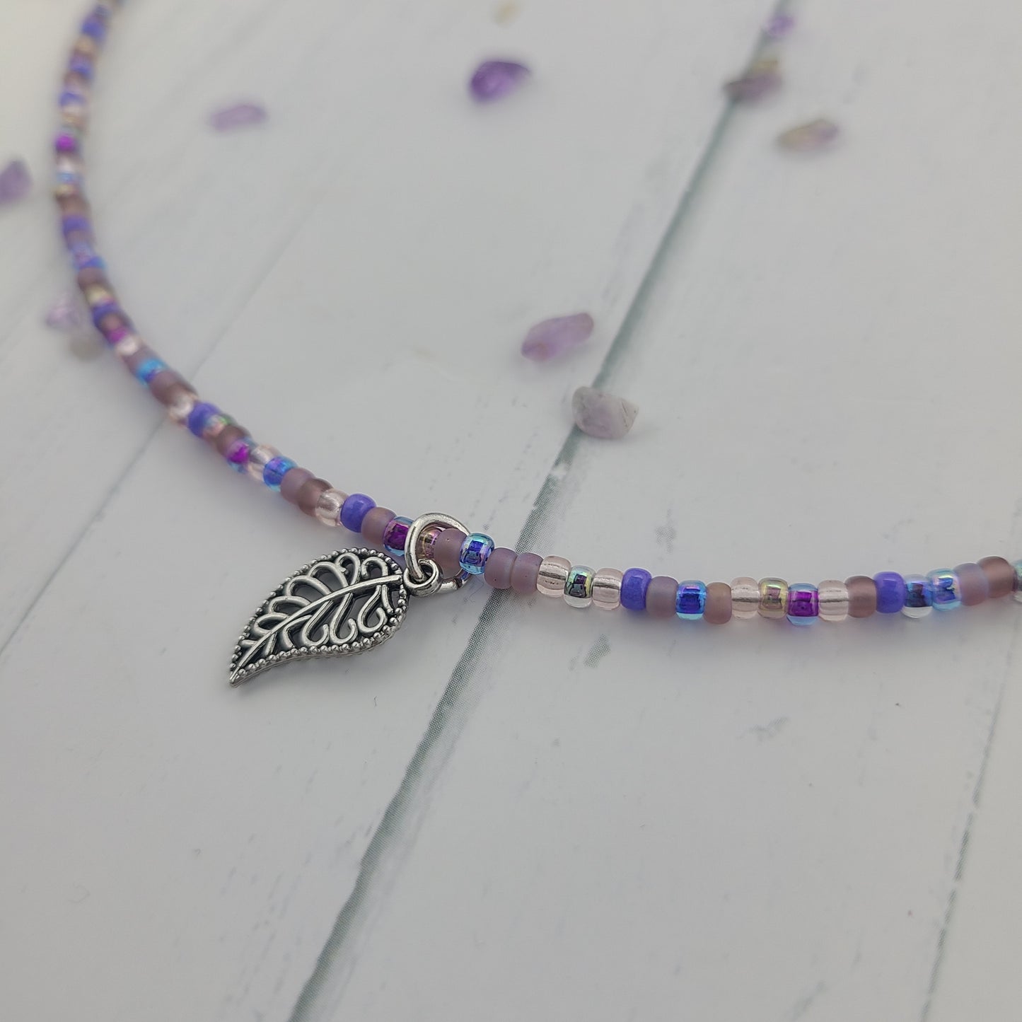 Handmade Purple glass seed bead necklace with metal leaf charm and a stainless steel clasp and chain