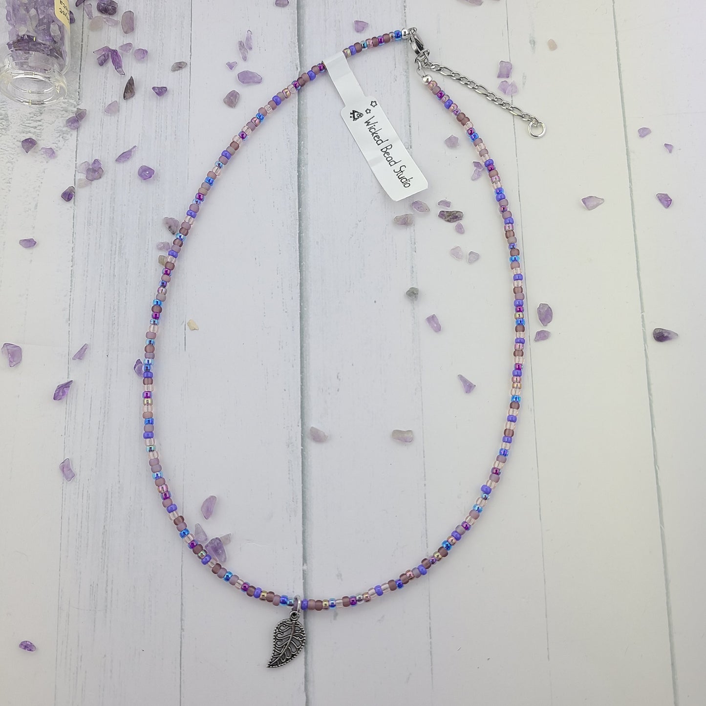 Handmade Purple glass seed bead necklace with metal leaf charm and a stainless steel clasp and chain