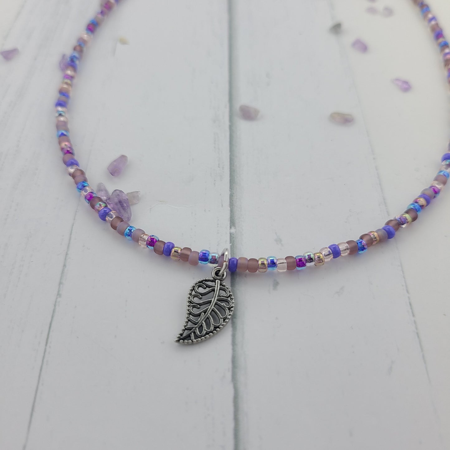 Handmade Purple glass seed bead necklace with metal leaf charm and a stainless steel clasp and chain