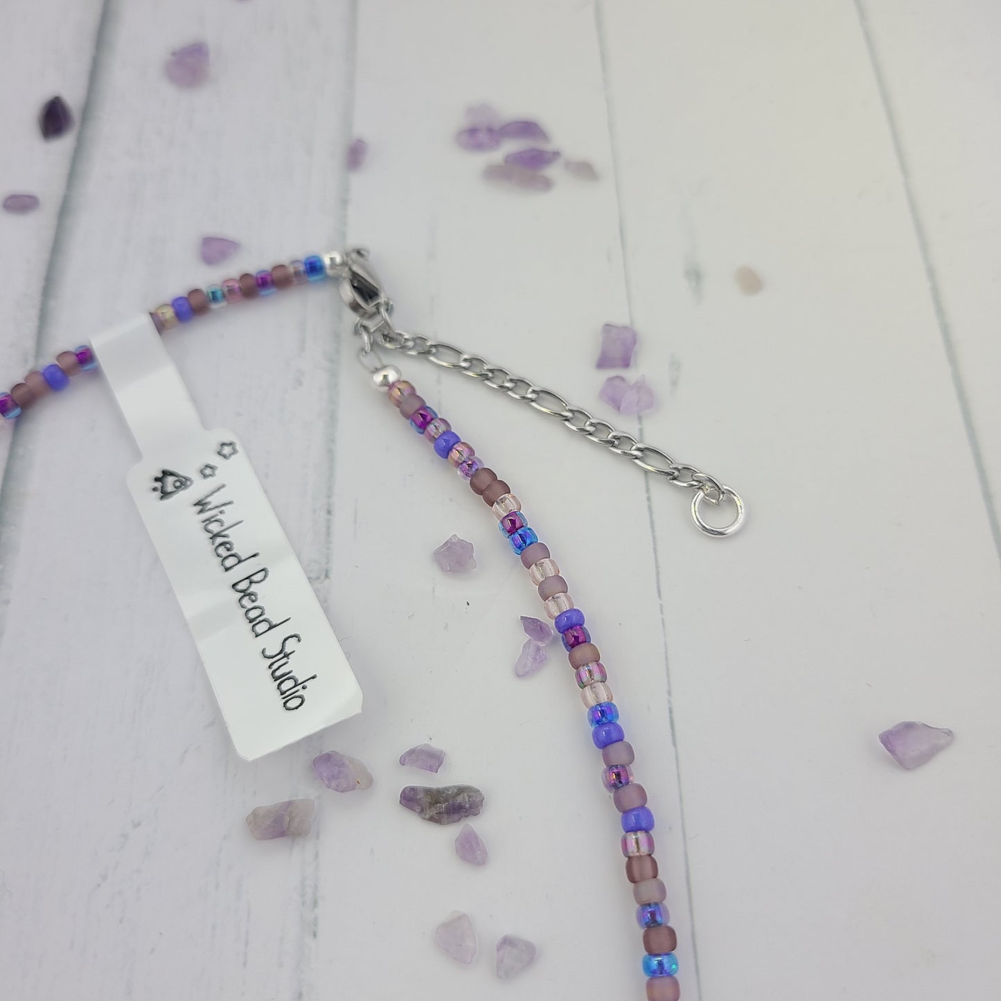 Handmade Purple glass seed bead necklace with metal leaf charm and a stainless steel clasp and chain